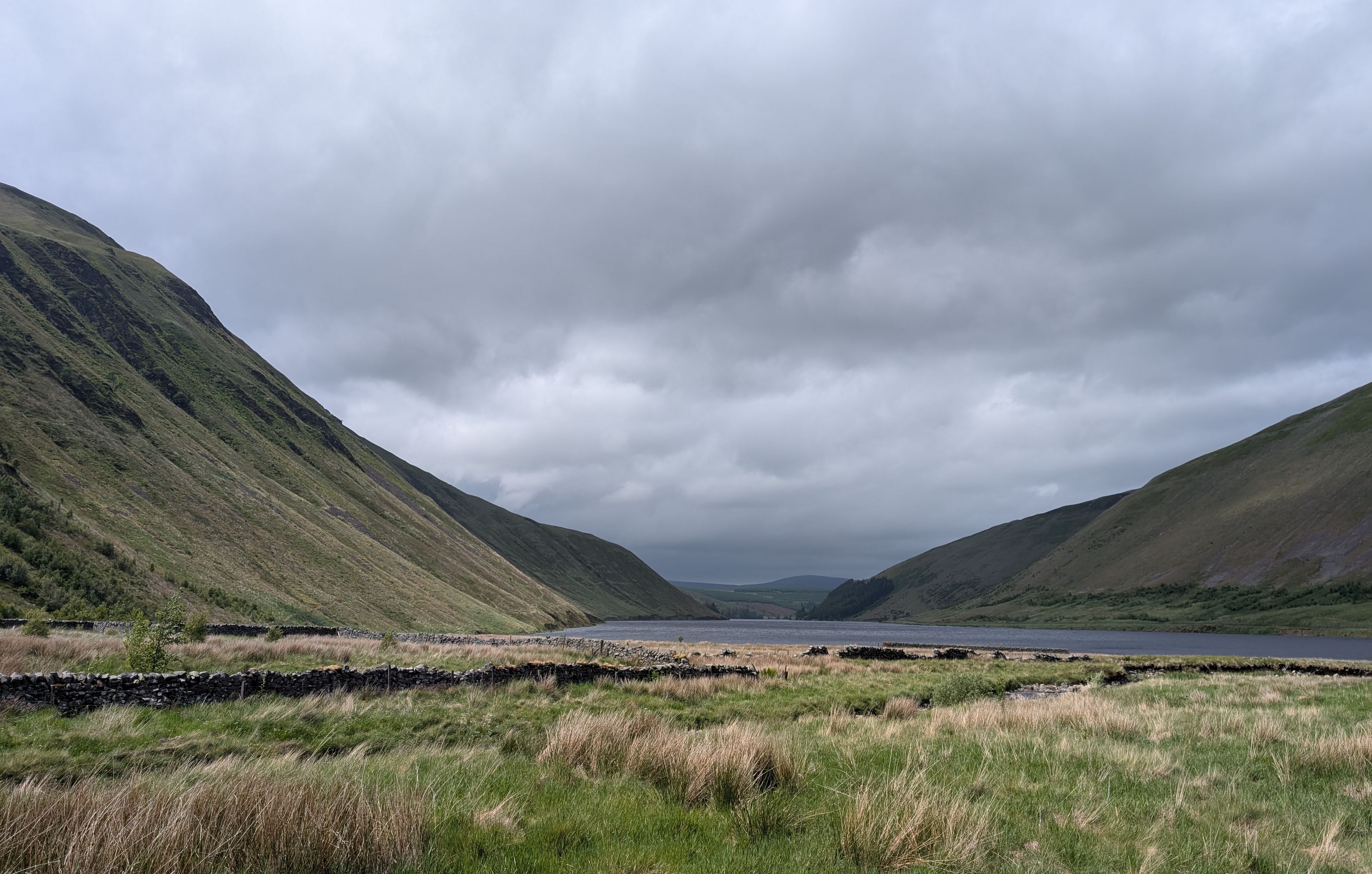 A massive V formed by valley sides with a lake at the centre